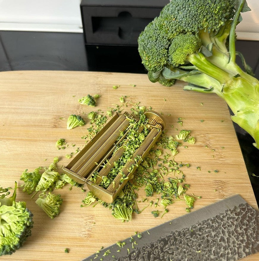 GoldRoll Pro™ rolling machine used for perfectly tight rolls on a cutting board